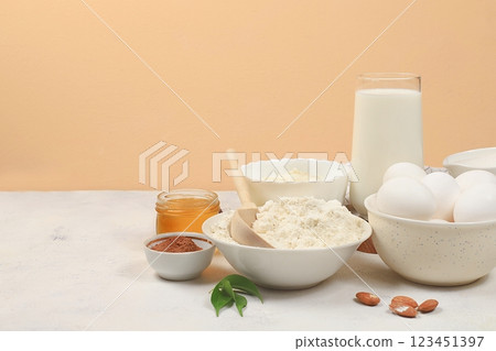 Kitchen background for baking and cooking cake,bread,confectionery and ingredients for cooking,milk,honey,flour,salt,sugar,eggs and cream on pastel background with place for text,selective focus, Kitchen background for baking and cooking cake,bread,confectionery and ingredients for cooking,milk,honey,flour,salt,sugar,eggs and cream on pastel background with place for text,selective focus, 123451397
