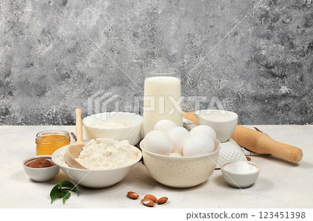 Kitchen background for baking and making cake,bread,confectionery and ingredients for cooking,milk,honey,flour,salt,sugar,eggs and cream on concrete background with place for text,selective focus, 123451398