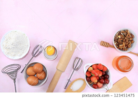 Kitchen background, cooking, Strawberry cherry pie recipe. Eggs, flour, sugar, strawberries and honey, top view, flat lay. Bakery background, modern bakery concept, selective focus 123451475