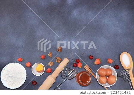 The recipe for making strawberry cherry pie. Eggs, flour, Sazar, strawberries and honey, top view, flat lay. Background of bakery products, the concept of a modern bakery 123451481
