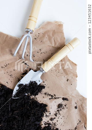 Gardening tools on brown paper with fresh soil for horticulture and planting Gardening tools on brown paper with fresh soil for horticulture and planting 123451632