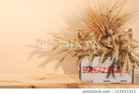 Ears of rye and wheat in a wooden box on a rustic table with space for text, modern bakery and harvest concept, healthy natural food, selective focus Ears of rye and wheat in a wooden box on a rustic table with space for text, modern bakery and harvest concept, healthy natural food, selective focus 123451915