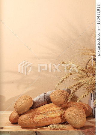 Freshly baked homemade bread, french sourdough baguette with crispy crust and ears of rye and wheat on wooden background with place for text, modern bakery concept, healthy natural food, selective Freshly baked homemade bread, french sourdough baguette with crispy crust and ears of rye and wheat on wooden background with place for text, modern bakery concept, healthy natural food, selective 123451918