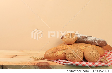 Freshly baked homemade bread, french sourdough baguette with crispy crust on wooden background with place for text, modern bakery concept, healthy natural food, selective focus Freshly baked homemade bread, french sourdough baguette with crispy crust on wooden background with place for text, modern bakery concept, healthy natural food, selective focus 123452001