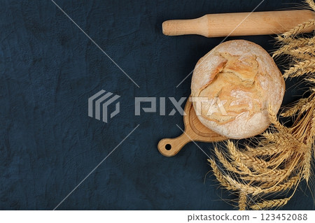 Freshly baked homemade bread, round sourdough cereal loaf with crispy crust and ears of rye and wheat on a concrete background with space for text, modern baking concept, healthy natural food, Freshly baked homemade bread, round sourdough cereal loaf with crispy crust and ears of rye and wheat on a concrete background with space for text, modern baking concept, healthy natural food, 123452088