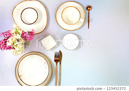Elegant festive table setting. Cutlery with flowers on a plate on a marble background., menu layout in a cafe or restaurant, festive composition with a bouquet of hyacinths, kitchen background. Elegant festive table setting. Cutlery with flowers on a plate on a marble background., menu layout in a cafe or restaurant, festive composition with a bouquet of hyacinths, kitchen background. 123452372