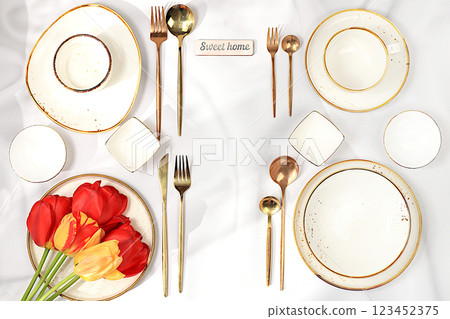 Elegant festive table setting, menu design in a cafe or restaurant for congratulations and a party, cutlery with flowers on a plate, festive composition with a bouquet of tulips, beautiful kitchen Elegant festive table setting, menu design in a cafe or restaurant for congratulations and a party, cutlery with flowers on a plate, festive composition with a bouquet of tulips, beautiful kitchen 123452375