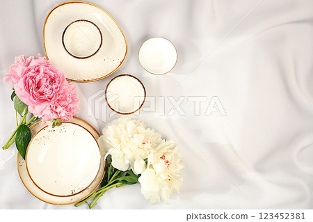 Elegant festive table setting, menu design in a cafe or restaurant for congratulations and a party, cutlery with flowers on a plate on a marble background, festive composition with a bouquet of 123452381