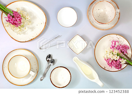 Elegant festive table setting, menu layout in a cafe or restaurant, cutlery with flowers on a plate on a marble background, festive composition with a bouquet of hyacinths, kitchen background. 123452388