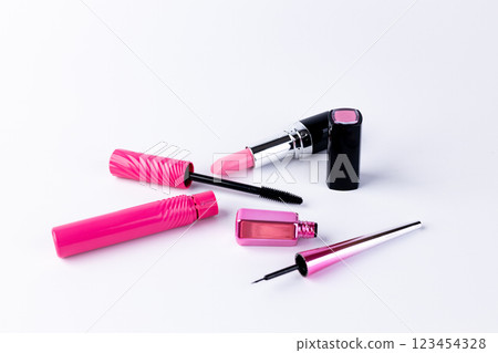 Vibrant Collection of Pink Cosmetics Including Lipstick, Mascara, and Nail Polish Laid Out Against a Clean White Background for an Eye-Catching Visual Appeal 123454328
