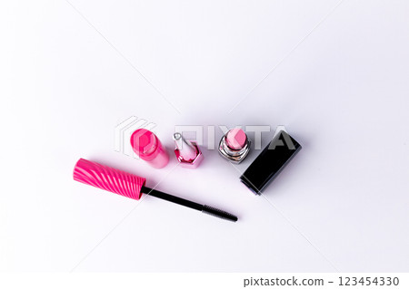 An Array of Vibrant Makeup Essentials Displayed on a Smooth White Surface Featuring a Mascara, Lipsticks, and a Glossy Lip Product for Beauty Enthusiasts 123454330