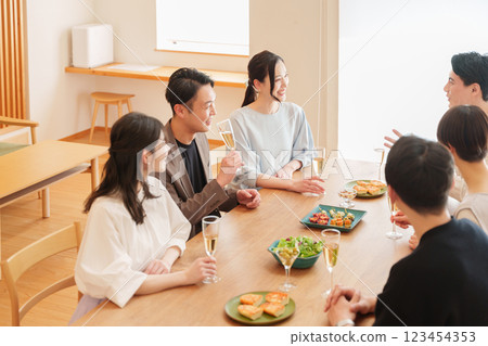 Men and women having a home party Men and women having a home party 123454353