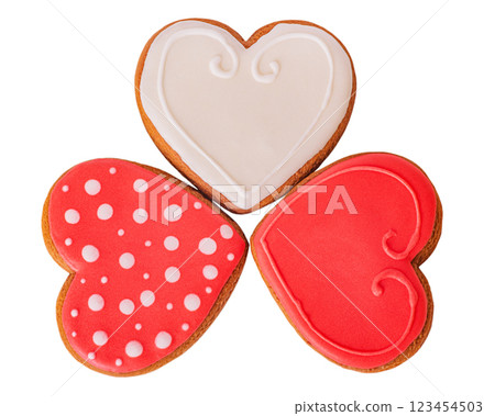 Three gingerbread cookies red, white and red with polka dots isolate on a white background. Three gingerbread cookies red, white and red with polka dots isolate on a white background. 123454503