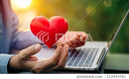 Love and connection in the digital age: Iconic image of a laptop and a red heart 123454761