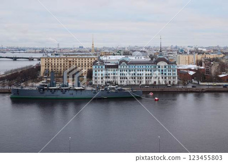 A historic ship now docks by the river in a vibrant urban setting, adding charm 123455803
