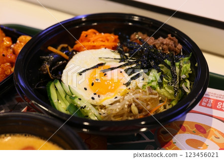 Enjoy a delicious plate of Bibimbap that includes a perfectly cooked egg and fresh vegetables 123456021