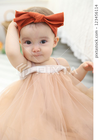 Baby posing while looking straight ahead 123456114