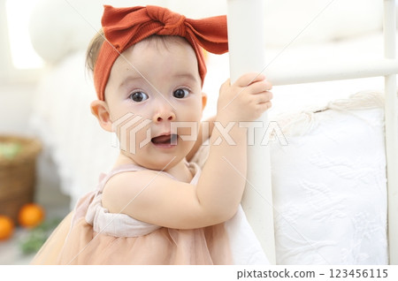Baby standing with a surprised expression 123456115