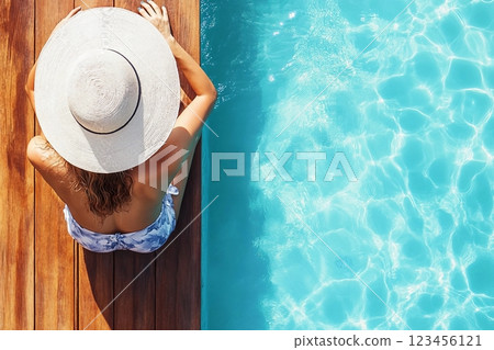 Summer holiday fashion concept tanning woman wearing sun hat on a wooden pier view from above Summer holiday fashion concept tanning woman wearing sun hat on a wooden pier view from above 123456121