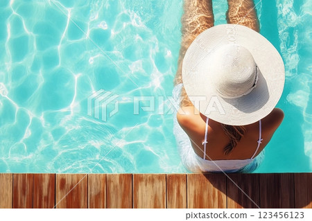 Summer holiday fashion concept tanning woman wearing sun hat on a wooden pier view from above 123456123