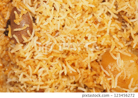 Flavorful rice dish featuring golden grains and tender pieces of meat 123456272