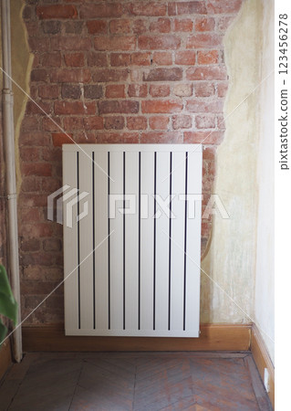 An elegant radiator beautifully placed against an exposed brick wall for stunning decor style An elegant radiator beautifully placed against an exposed brick wall for stunning decor style 123456278