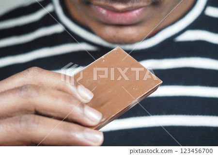 Sweet anticipation of chocolate treat held close to lips Sweet anticipation of chocolate treat held close to lips 123456700
