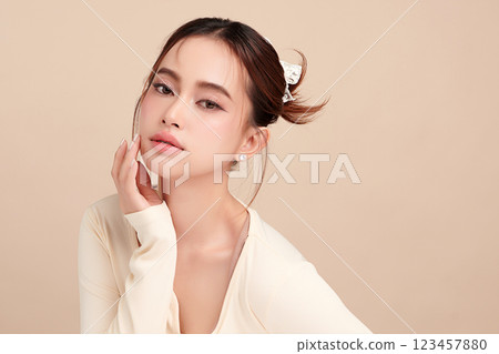 Beautiful young asian woman with clean fresh skin on beige background, Face care, Facial treatment, Cosmetology, beauty and spa, Asian women portrait. 123457880