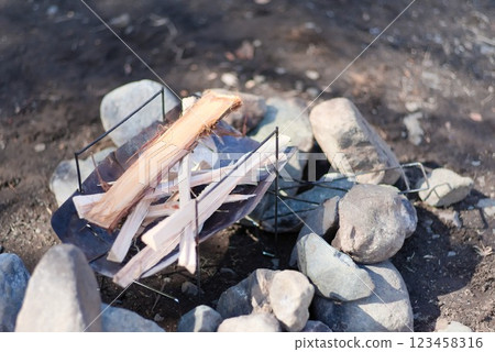 Firewood lined up on a fire pit before burning 123458316