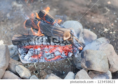 Burning charcoal at a campsite - bonfire scene - 123458623