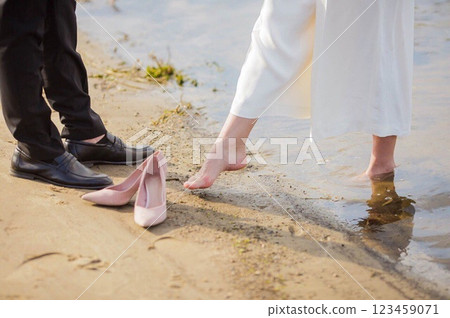 the bride and groom are standing in the water the bride and groom are standing in the water 123459071