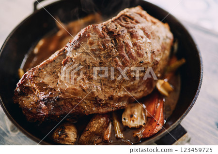 Baked roast beef with vegetables is in a frying pan. Top view Baked roast beef with vegetables is in a frying pan. Top view 123459725
