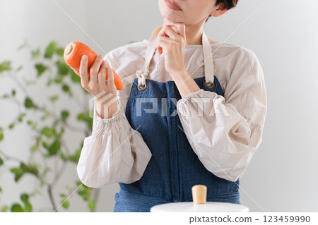 A young woman cooking in an apron Lifestyle image A young woman cooking in an apron Lifestyle image 123459990