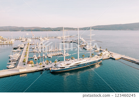 Large yacht with lowered sails stands at the marina pier. Drone Large yacht with lowered sails stands at the marina pier. Drone 123460245