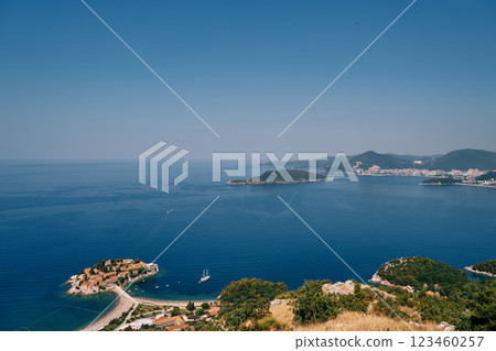 Sailboat sails along the Bay of Kotor past the island of Sveti Stefan. Montenegro. Top view Sailboat sails along the Bay of Kotor past the island of Sveti Stefan. Montenegro. Top view 123460257