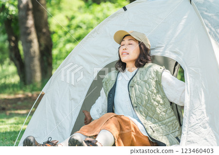 Woman enjoying camping glamping taking a deep breath at a campsite 123460403