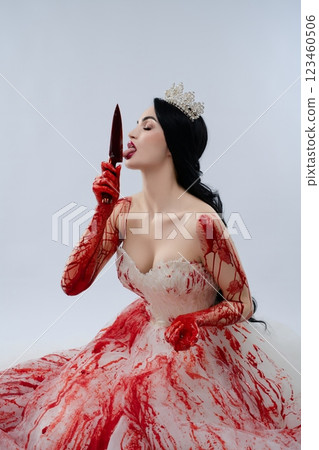 Bride in bloody lingerie wields a knife, radiating dark elegance 123460506