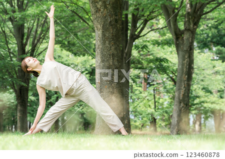 Young Asian woman doing park yoga, yoga, pilates, stretching in forest/park Young Asian woman doing park yoga, yoga, pilates, stretching in forest/park 123460878