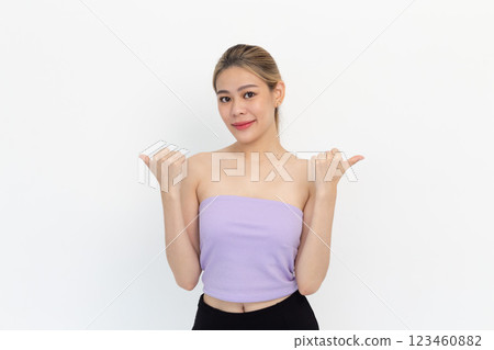 Portrait of Happy asian young woman smiling against made finger thumbs up OK gesture on white background 123460882