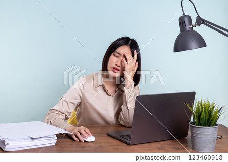 Tired, exhausted Asian woman with a laptop, problems with the project, feeling depressed, laziness in office Tired, exhausted Asian woman with a laptop, problems with the project, feeling depressed, laziness in office 123460918