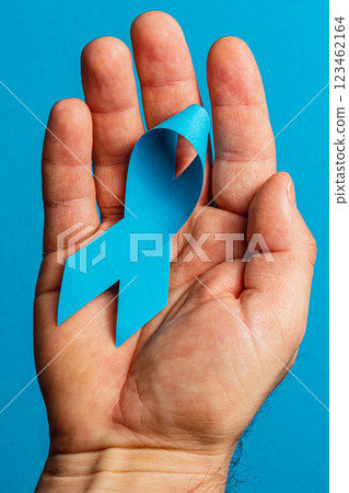 Blue ribbon symbolizing awareness for cancer detection and prevention 123462164