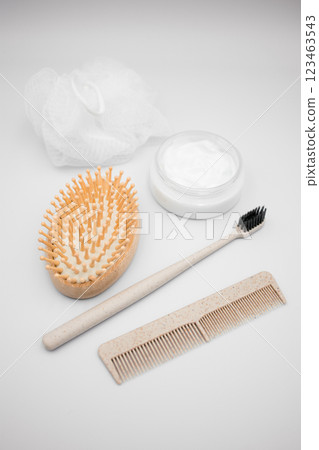 Body and hair care items on white background. Brush, comb, toothbrush, cream, loofah 123463543