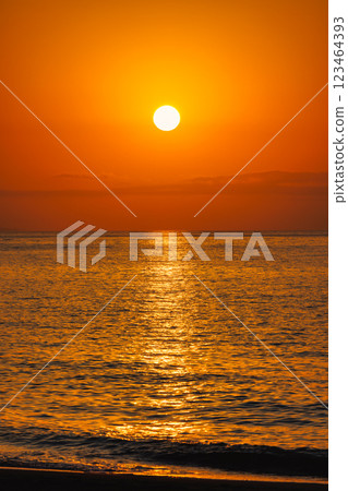 Sunrise view from Malaga seaside city in Andalusia, Spain, Europe. Golden sunrise over calm ocean waters. The sun dips below the horizon, casting a warm, orange glow. Sunrise view from Malaga seaside city in Andalusia, Spain, Europe. Golden sunrise over calm ocean waters. The sun dips below the horizon, casting a warm, orange glow. 123464393
