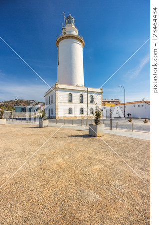 Malaga, seaside city in Andalusia, Spain, Europe. Coastal lighthouse on a sunny day, standing tall against a clear blue sky. A tranquil scene of maritime architecture. Malaga, seaside city in Andalusia, Spain, Europe. Coastal lighthouse on a sunny day, standing tall against a clear blue sky. A tranquil scene of maritime architecture. 123464434