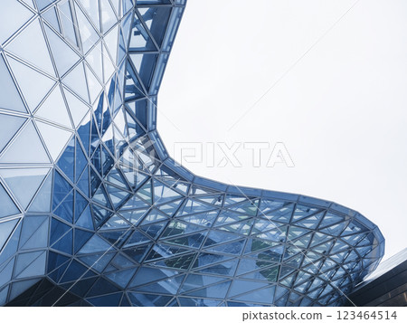 Glass facade Steel curve frame Modern building blue reflection Architecture details Futuristic background Glass facade Steel curve frame Modern building blue reflection Architecture details Futuristic background 123464514