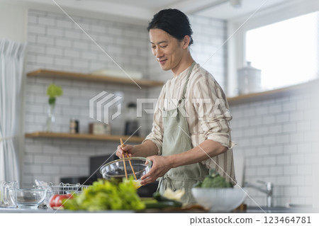 A man in his 40s cooking in the kitchen 123464781