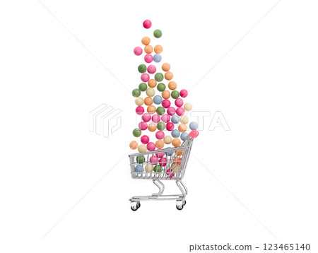 candies falling into a supermarket cart on a white background 123465140