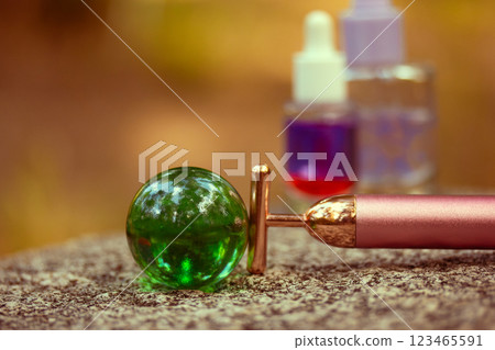 A golden electrical facial T-massager on a grey stone. Beauty care treatment anti-aging tool for massaging. Female daily routine. Ecological world. A golden electrical facial T-massager on a grey stone. Beauty care treatment anti-aging tool for massaging. Female daily routine. Ecological world. 123465591