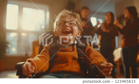 Emotional portrait of a joyful child with cerebral palsy enjoying time with family and friends indoors in soft warm light 123465615