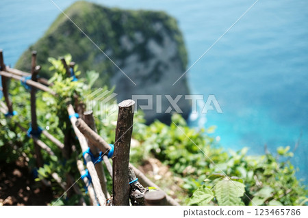 Wooden fences blocking the walkway on the mountain Kelingking beach and sea of Bali, Indonesia Wooden fences blocking the walkway on the mountain Kelingking beach and sea of Bali, Indonesia 123465786